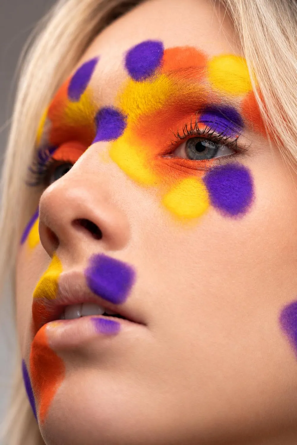 Profile view of a colourful creative glam look